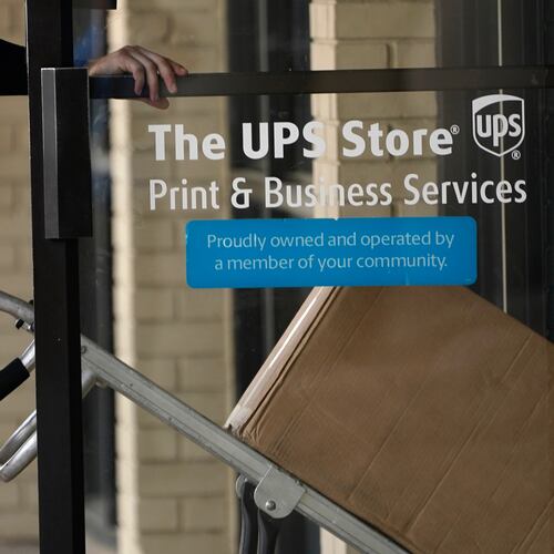 FILE - A UPS driver enters a United Parcel Service store with packages in Jackson, Miss., July 26, 2021. (AP Photo/Rogelio V. Solis, File)