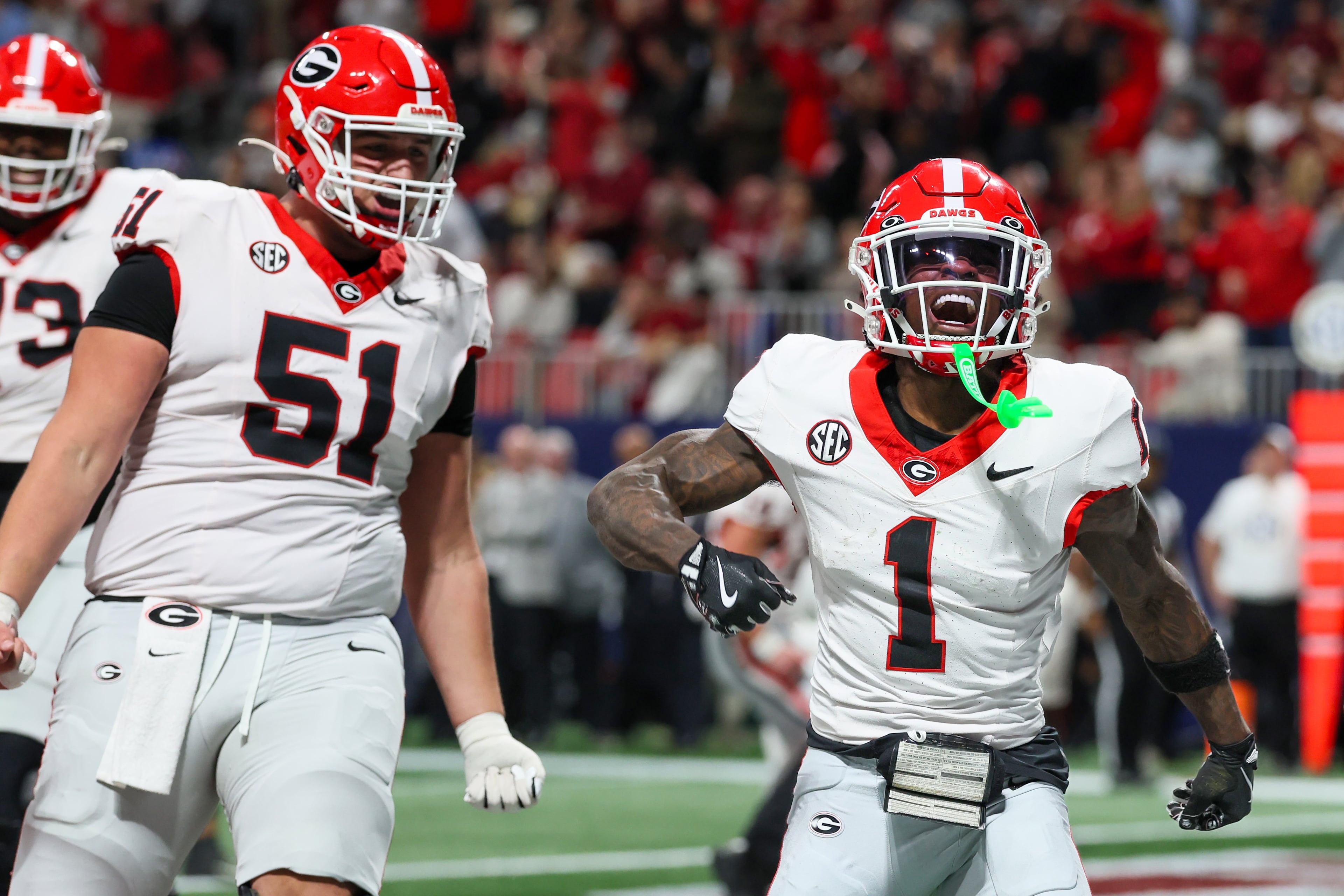 Georgia wide receiver Zachariah Branch (1) reacts after scoring a touchdown against Alabama during the fourth quarter of the SEC Championship game at Mercedes-Benz Stadium, Saturday, Dec. 6, 2025, in Atlanta. (Jason Getz / AJC)