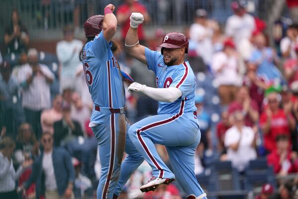 Philadelphia Phillies' Rafael Marchán, right, and Brandon Marsh celebrate after Marchán's two-run home run against Atlanta Braves pitcher AJ Smith-Shawver during the third inning in the first baseball game of a doubleheader Thursday, May 29, 2025, in Philadelphia. (AP Photo/Matt Slocum)