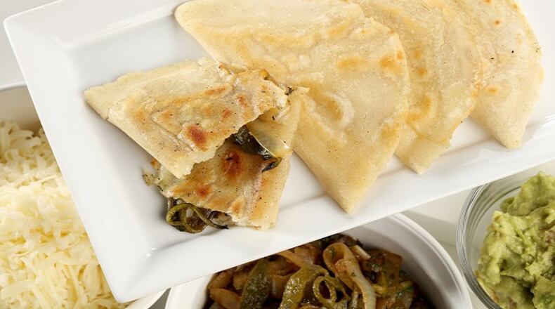 Quesadillas with fresh corn masa are filled with sauteed poblanos and onions, folded and sealed, then browned in a skillet. Food styling by Mark Graham. (Michael Tercha/Chicago Tribune/TNS)