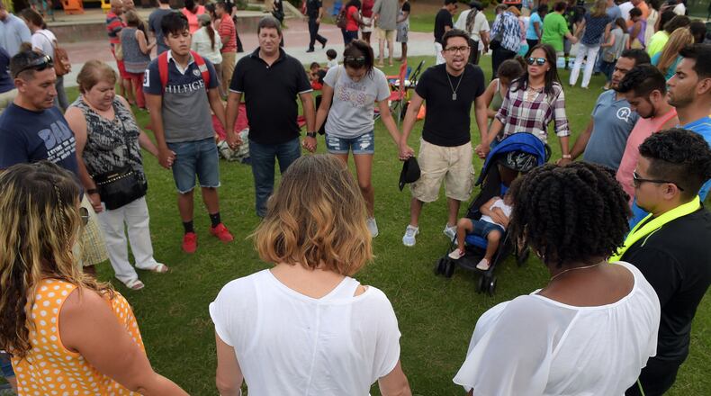 Members of several churches gather for a “Lilburn United” rally in Lilburn City Park July 24. They sought unity in the face of racial divisions that continue to dominate national headlines. KENT D. JOHNSON/kdjohnson@ajc.com