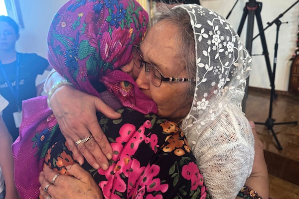 Two women embrace during the canonization ceremony of St. Olga in Kwethluk, Alaska, on June 19, 2025, which made her the first female Orthodox saint in North America. (AP Photo/Mark Thiessen)