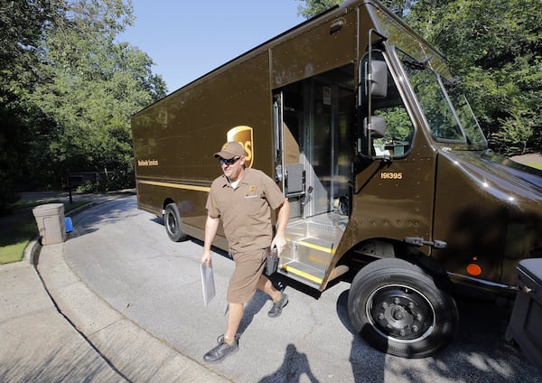 Driver Dan Partyka delivers an overnight package last year. UPS is a bellwether of the global economy, providing unique insights into economic sentiment. (Bob Andres/AJC/TNS)