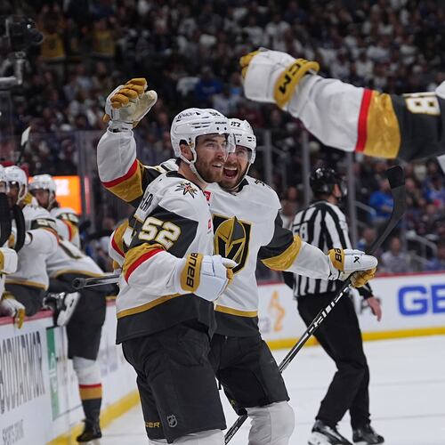 Vegas Golden Knights defenseman Dylan Coghlan, front left, is congratulated after scoring a goal by defenseman Shea Theodore, back left, and center Tomas Hertl during the second period in Game 1 of the Western Conference finals NHL hockey Stanley Cup playoff series against the Colorado Avalanche Wednesday, May 20, 2026, in Denver. (AP Photo/David Zalubowski)