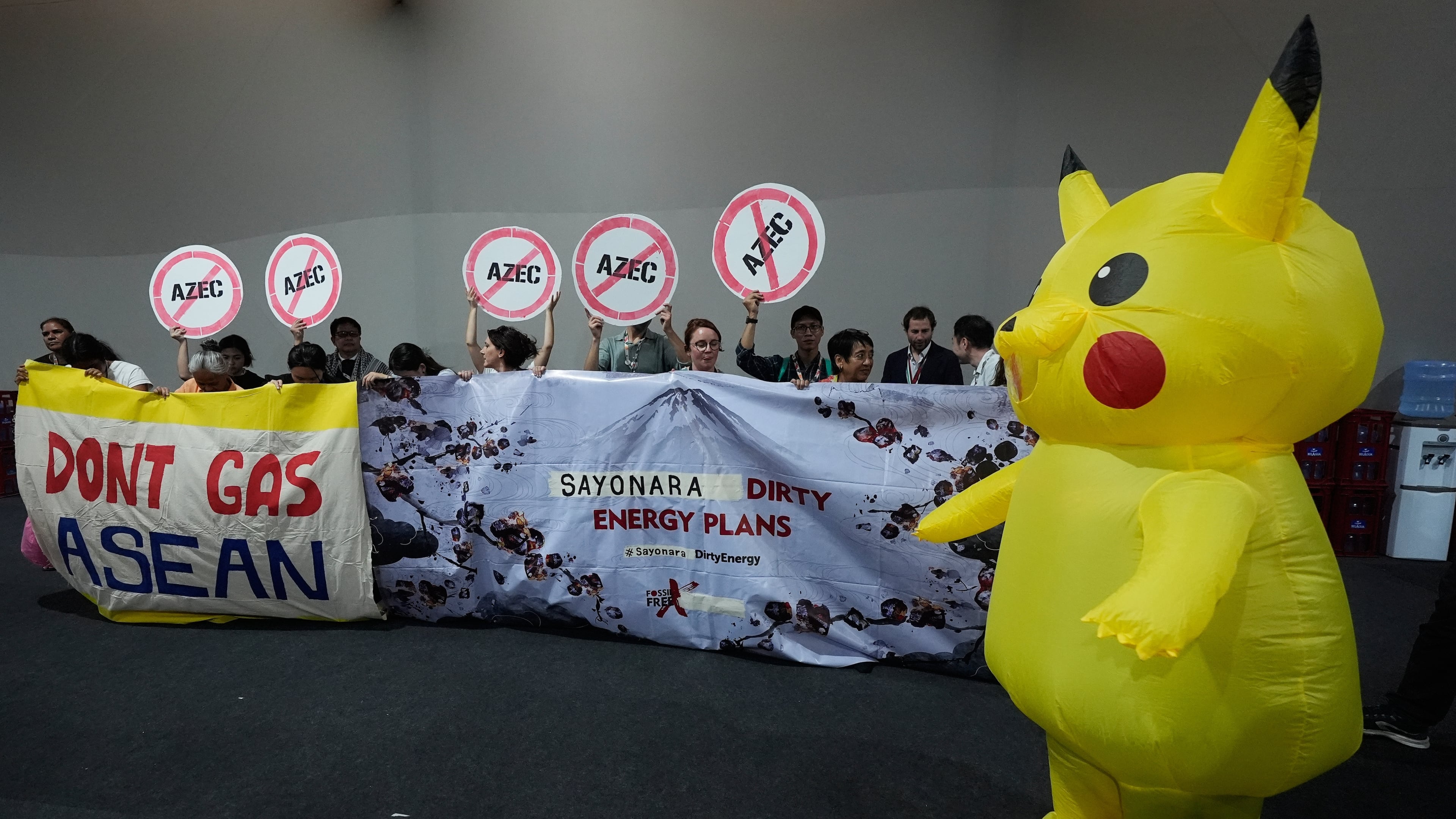 Activists, and one dressed in a Pikachu costume, protest Japan's financing of coal and natural gas projects during the COP30 U.N. Climate Summit, Friday, Nov. 14, 2025, in Belem, Brazil. (AP Photo/Fernando Llano)
