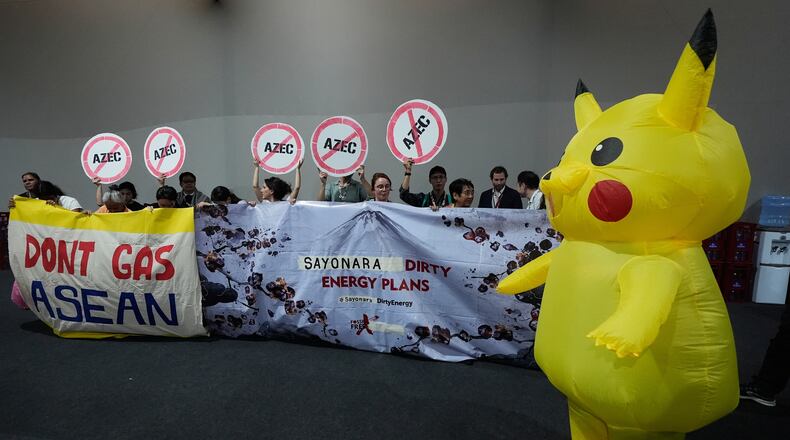 Activists, and one dressed in a Pikachu costume, protest Japan's financing of coal and natural gas projects during the COP30 U.N. Climate Summit, Friday, Nov. 14, 2025, in Belem, Brazil. (AP Photo/Fernando Llano)