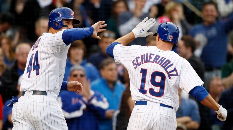 Chicago Cubs' Anthony Rizzo, left, celebrates with Nate Schierholtz after Rizzo scored on Schierholtz's sacrifice fly against the Atlanta Braves during the eighth inning of a baseball game on Saturday, Sept. 21, 2013, in Chicago. (AP Photo/Andrew A. Nelles)