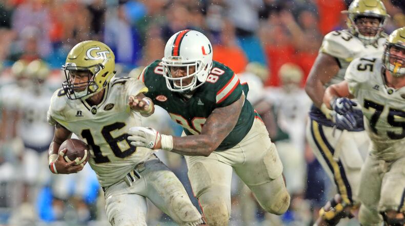 Miami defensive lineman R.J. McIntosh (80) chases Georgia Tech quarterback TaQuon Marshall (16) late in the fourth quarter at Hard Rock Stadium in Miami on Saturday, Oct. 14, 2017. The host Hurricanes won, 25-24. (Al Diaz/Miami Herald/TNS)