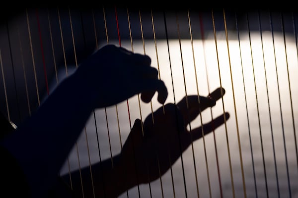 A member of the Vienna Symphony Orchestra plays on harp during "The Blue Danube" waltz as it is transmitted into deep space towards Voyager 1. in Vienna, Austria, on Saturday, May 31, 2025. (AP Photo/Denes Erdos)