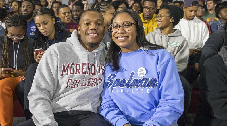 Morehouse College senior Phil Edwards (left) and his girlfriend Spelman College senior Sydney Pascal (right) pose for a photo before the start of an Elizabeth Warren campaign stop at Clark Atlanta University in Atlanta, Thursday, November 21, 2019. ALYSSA POINTER/AJC
