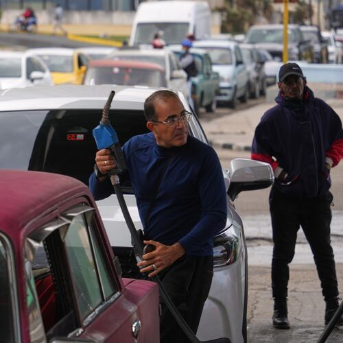A driver refuels others wait in a long line behind to fill up at a gas station in Havana, Cuba, Tuesday, Jan. 27, 2026. (AP Photo/Ramon Espinosa)