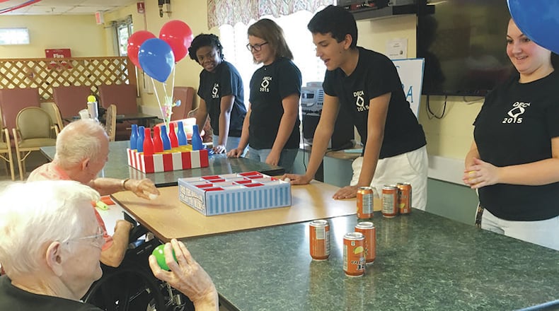 Students (from left) Tahj Brown, Kara Landsiedel, Maverick Borges and Cydney Moore staff a games table at the party.