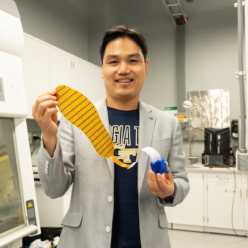 Lead researcher Hong Yeo holds up the 3D-printed shoe insert, which is designed to better monitor foot placement. (Courtesy Georgia Tech)