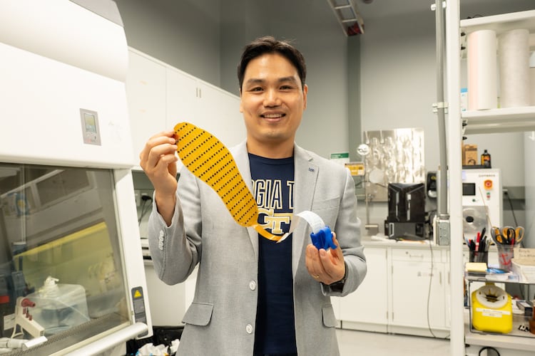 Lead researcher Hong Yeo holds up the 3D-printed shoe insert, which is designed to better monitor foot placement. (Courtesy Georgia Tech)