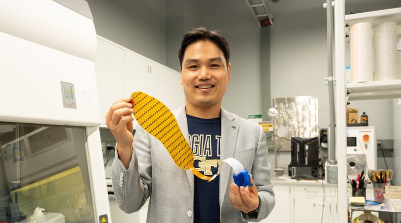 Lead researcher Hong Yeo holds up the 3D-printed shoe insert, which is designed to better monitor foot placement. (Courtesy Georgia Tech)