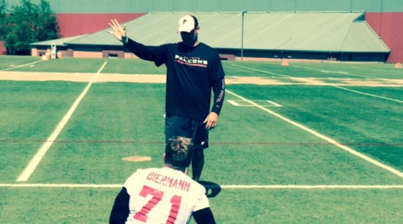 Outside linebacker/defensive end Kroy Biermann stretching before an OTA practice. Can he make it back from a ruptured achilles tendon? (By D. Orlando Ledbetter/dledbetter@ajc.com)