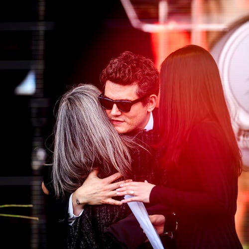 John Mayer embraces Natascha Münter during a public memorial for her husband, Grateful Dead guitarist Bob Weir, on Saturday, Jan. 17, 2026, in San Francisco. (AP Photo/Noah Berger)