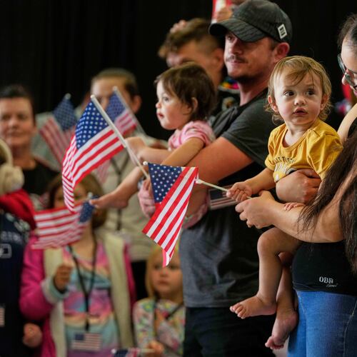 FILE - Afrikaner refugees from South Africa holding American flags arrive, May 12, 2025, at Dulles International Airport in Dulles, Va. (AP Photo/Julia Demaree Nikhinson, File)