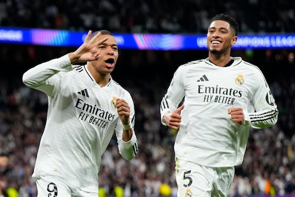 FILE - Real Madrid's Kylian Mbappe, left, celebrates with Jude Bellingham after scoring his sides third goal during the Champions League playoff second leg soccer match between Real Madrid and Manchester City at the Santiago Bernabeu Stadium in Madrid, Spain, Wednesday, Feb. 19, 2025. (AP Photo/Manu Fernandez, File)