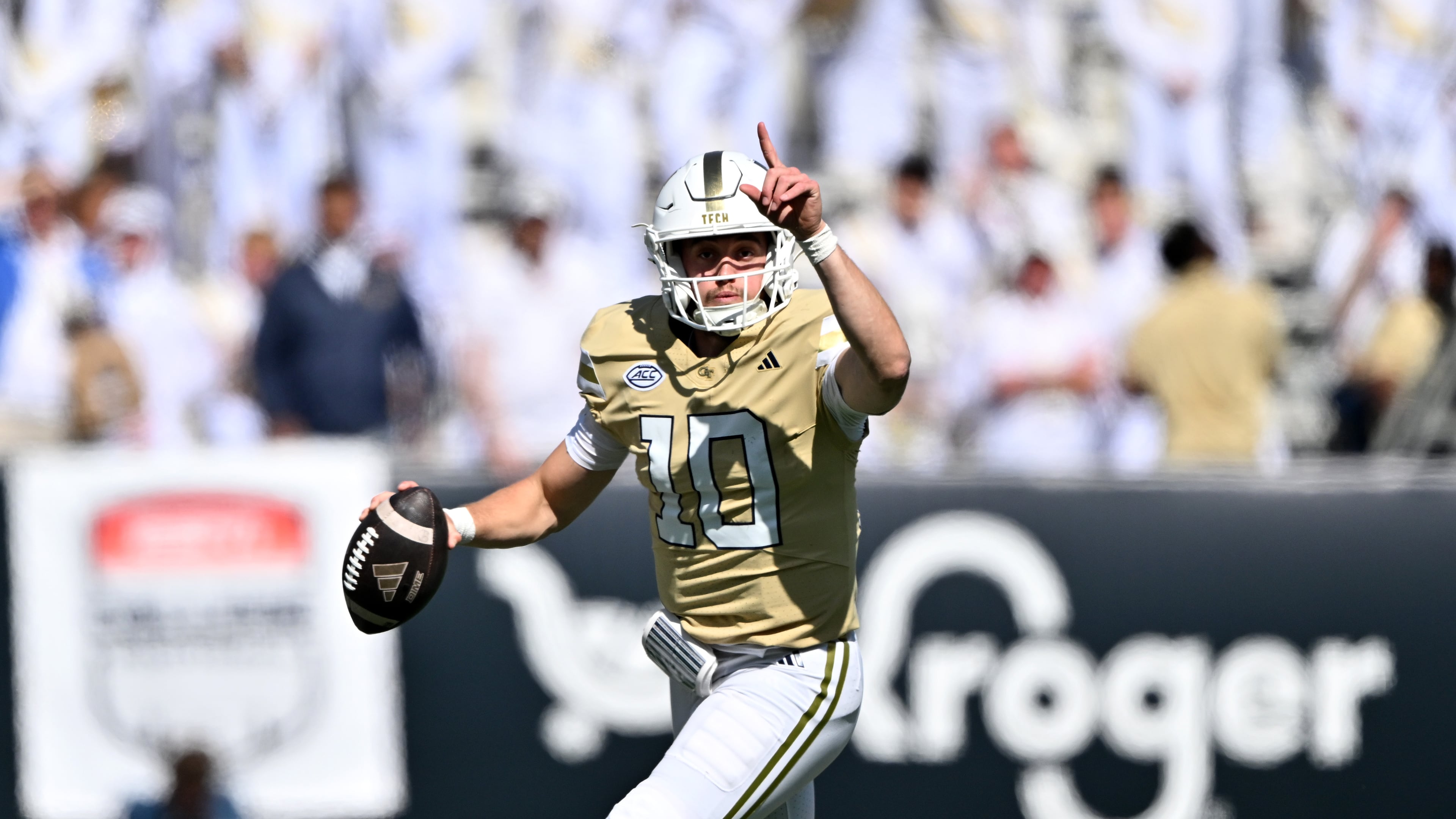Georgia Tech quarterback Haynes King (10) runs the ball against Syracuse defensive back Braheem Long Jr. (0) during the first half of an NCAA college football game at Bobby Dodd Stadium, Saturday, October 25, 2025 in Atlanta. (Hyosub Shin/AJC)