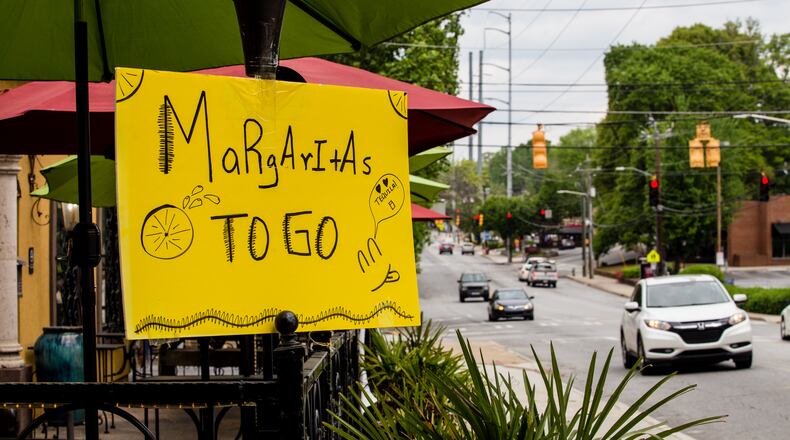 La Hacienda Mexican restaurant on Monroe Drive in Midtown offers margaritas to go Tuesday, April 7, 2020. Signs like these and others will be important to historians one day as they document how Georgians dealt with the pandemic. (Jenni Girtman for the Atlanta Journal Constitution)