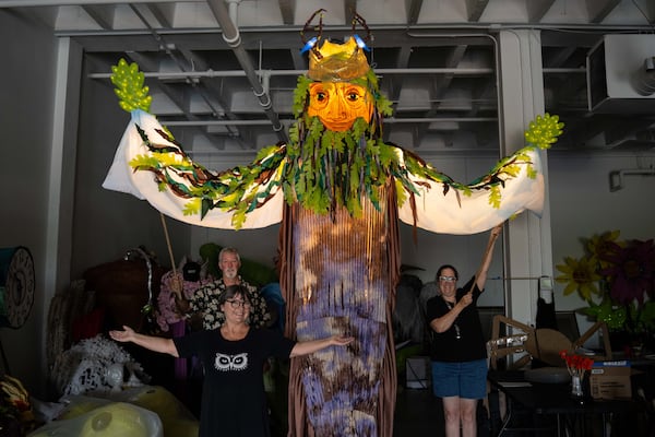 Chantelle Rytter (front left) stands with the Oak King during a rehearsal ahead of the Atlanta Beltline Lantern Parade. The Oak King will make its debut Saturday night as it lights up the Atlanta Beltline Southwest Trail. (Courtesy of Chantelle Rytter and Steve Eberhardt)