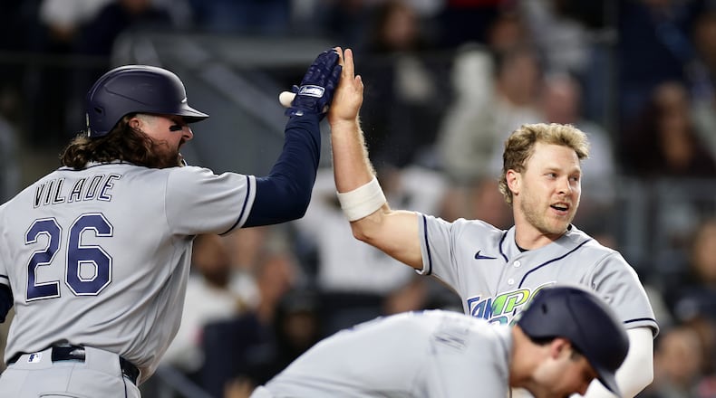 Tampa Bay Rays' Taylor Walls celebrates scoring with Ryan Vilade (26) in the seventh inning during the second baseball game of a doubleheader against the New York Yankees, Tuesday, Sept. 22, 2026, in New York. (AP Photo/Adam Hunger)