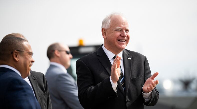 Minnesota Governor Tim Walz (center) awaits the arrival of US Vice President Kamala Harris at the Minneapolis-St. Paul International Airport in Saint Paul, Minnesota, on March 14, 2024. (Stephen Maturen/AFP via Getty Images/TNS)