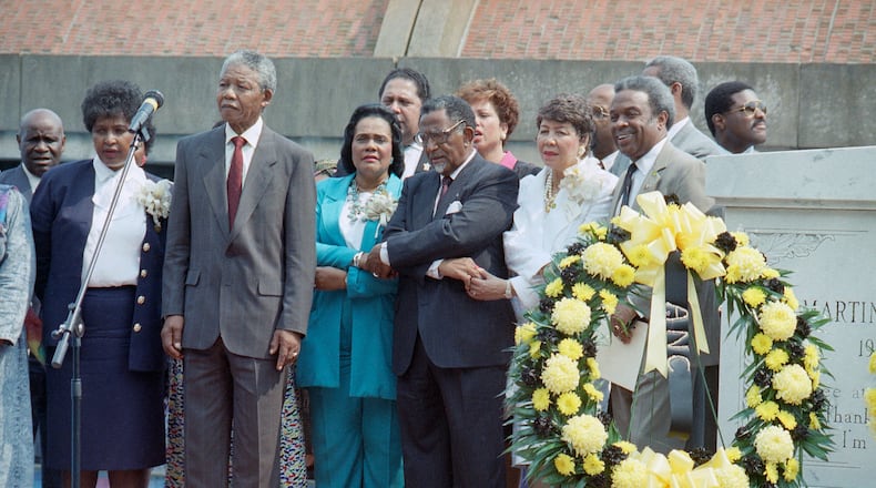Nelson Mandela pauses after laying a wreath at the tomb of the Rev. Martin Luther King Jr. in Atlanta on June 28, 1990. From left are Winnie Mandela, Nelson Mandela, King's widow Coretta Scott King, the Rev. Joseph Lowery, president of the Southern Christian Leadership Conference, and Evelyn Lowery.
