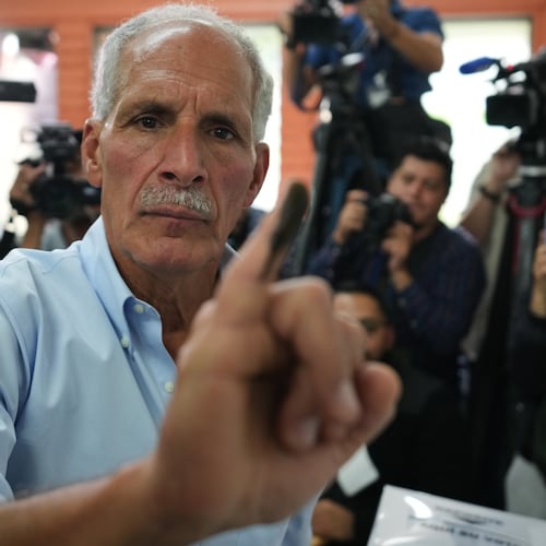 Nasry Asfura, presidential candidate for the National Party, shows his inked finger afterv voting in general elections in Tegucigalpa, Honduras, Sunday, Nov. 30, 2025. (AP Photo/Moises Castillo)