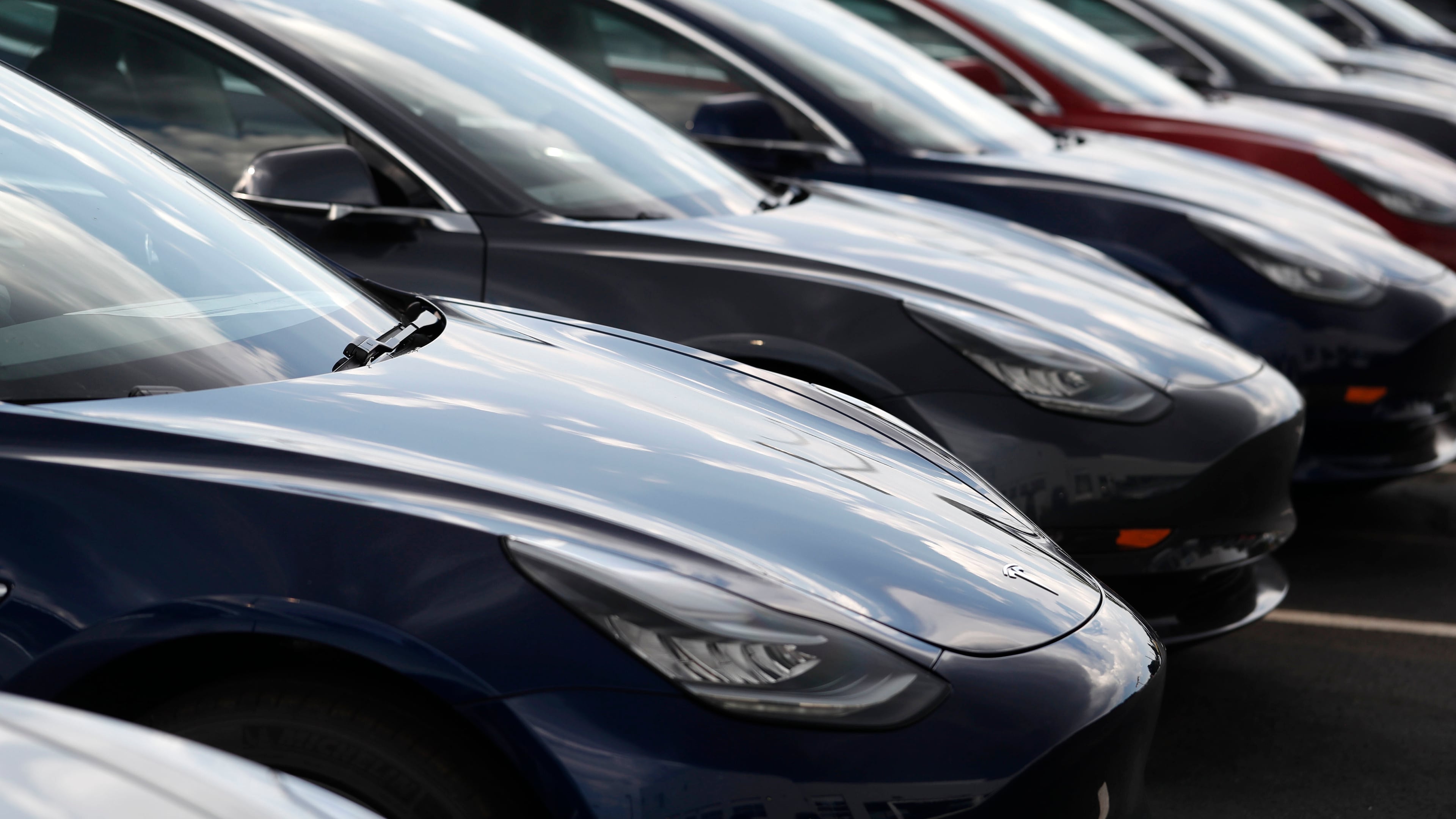 FILE - Several 2018 Model 3 sedans sit on display outside a Tesla showroom, July 8, 2018, in Littleton, Colo. (AP Photo/David Zalubowski, File)
