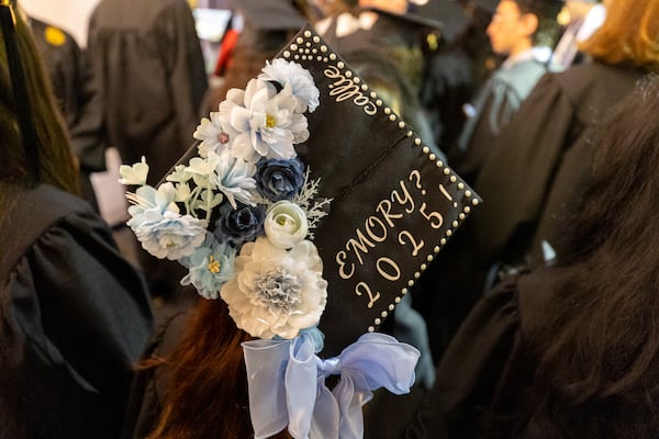 A student dons a decorated cap during the graduation ceremony at Emory University on Monday, May 12, 2025, in Atlanta. (Arvin Temkar/AJC)