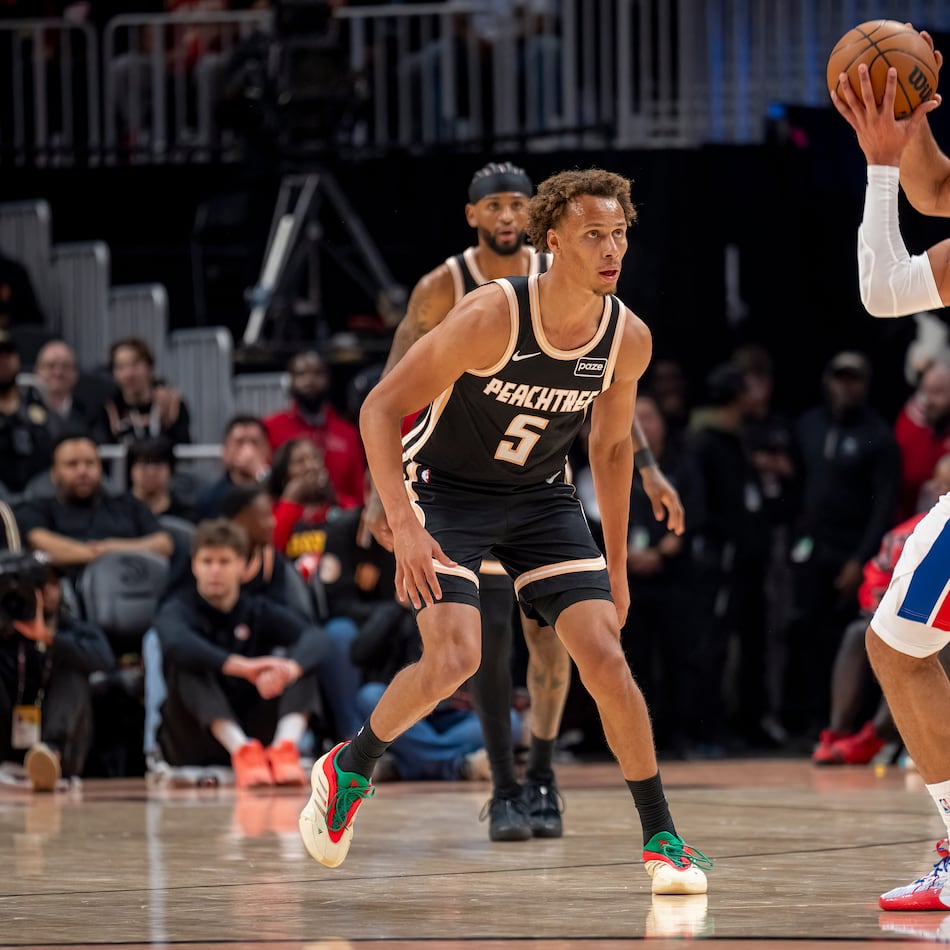 Atlanta Hawks guard Dyson Daniels (5) defends the goal against Detroit Pistons guard Cade Cunningham during the first half of an NBA basketball game, Tuesday, Nov. 18, 2025, in Atlanta. (AP Photo/Erik Rank)