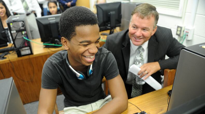 In this 2012 photo, sophomore Malik Miles (From left) shares a laugh with Fayette County Superintendent of Schools Jeff Bearden as he shows him how to do a self-assessment during the official launch of the Microsoft IT Academy at Fayette County High School in Fayetteville.