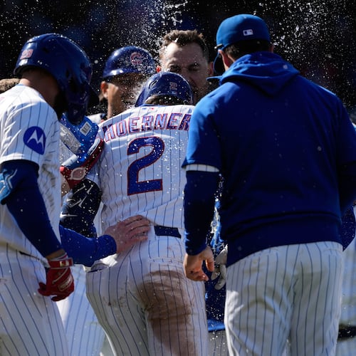 Chicago Cubs' Nico Hoerner (2) celebrates with teammates after hitting a sacrifice fly to New York Mets right fielder Tyrone Taylor during the 10th inning of a baseball game in Chicago, Sunday, April 19, 2026. (AP Photo/Nam Y. Huh)
