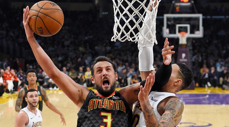 Atlanta Hawks guard Marco Belinelli shoots as Los Angeles Lakers forward Kyle Kuzma defends during the first half of a basketball game, Sunday, Jan. 7, 2018, in Los Angeles. (AP Photo/Mark J. Terrill)