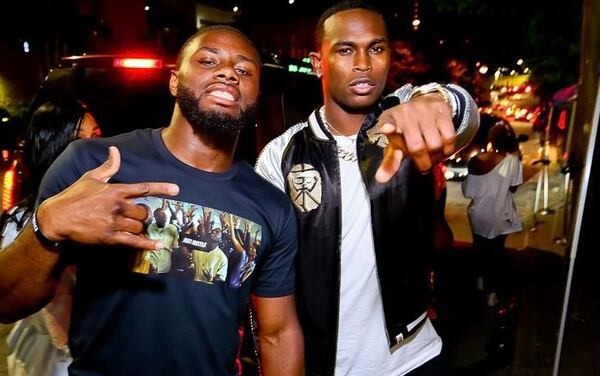 Two party goers take a moment for a picture at Opium.