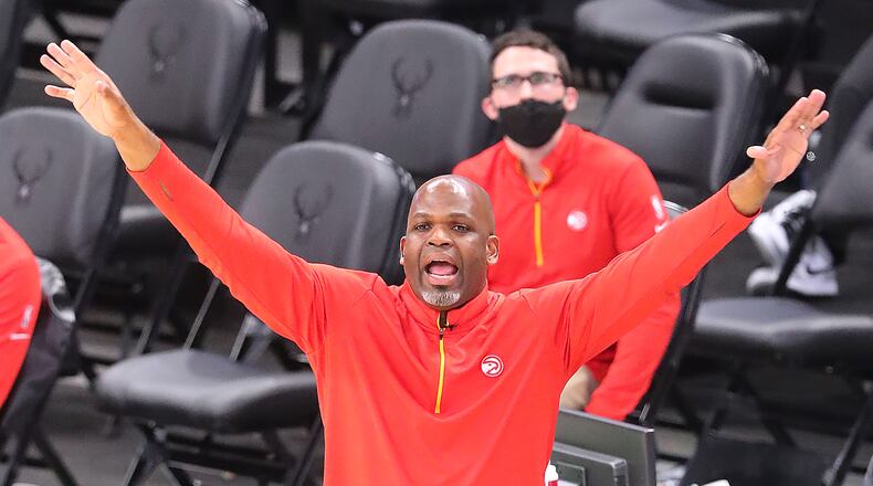 Hawks interim head coach Nate McMillan tries to get his players' attention on defense against the Milwaukee Bucks.   “Curtis Compton / Curtis.Compton@ajc.com”