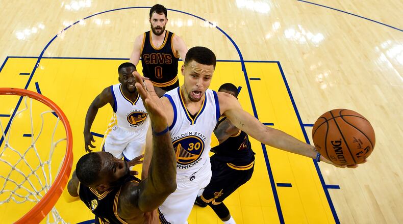 Stephen Curry (30) of Golden State goes up for a shot against LeBron James of Cleveland in the first half of Sunday’s Game 2 of the NBA Finals. (Photo by Bob Donnan/Getty Images)