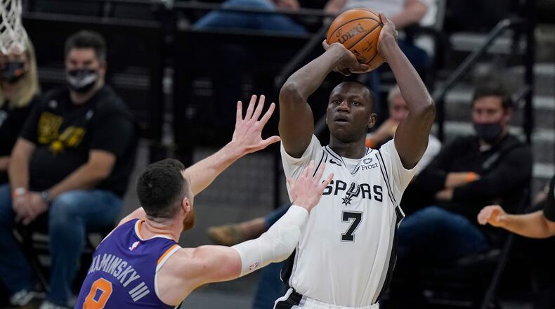 San Antonio Spurs center Gorgui Dieng (7) shoots over Phoenix Suns forward Frank Kaminsky (8) during the second half Saturday, May 15, 2021, in San Antonio. (Eric Gay/AP)