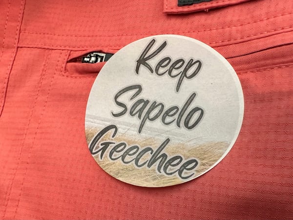 FILE - A sticker saying "Keep Sapelo Geechee" is worn on the shirt of George Grovner, a resident of the Hogg Hummock community on Sapelo Island, during a meeting of McIntosh County commissioners, Sept. 12, 2023, in Darien, Ga. AP Photo/Ross Bynum, File)