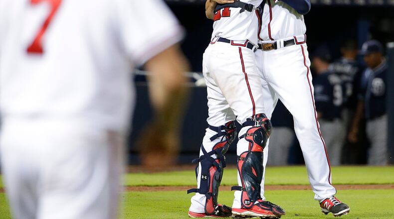 Braves reliever Jason Grilli hugs catcher Christian Bethancourt after closing out the ninth inning in the Braves' 6-5 win over San Diego Tuesday night. (AP Photo/David Goldman)