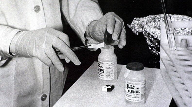 FILE - Bottles of Extra-Strength Tylenol are tested with a chemically treated paper that turns blue in the presence of cyanide at the Illinois Department of Health in Oct. 1982, in Chicago. (AP Photo/John Swart, File)