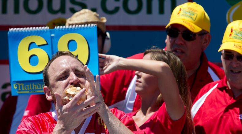 Joey Chestnut competes in Nathan's Famous Fourth of July International Hot Dog Eating Contest men's competition, Monday, July 4, 2016, in New York. Chestnut came in first eating 70 hot dogs and buns in 10 minutes. Matt Stonie came in second eating 53 hot dogs and buns in 10 minutes. (AP Photo/Mary Altaffer)