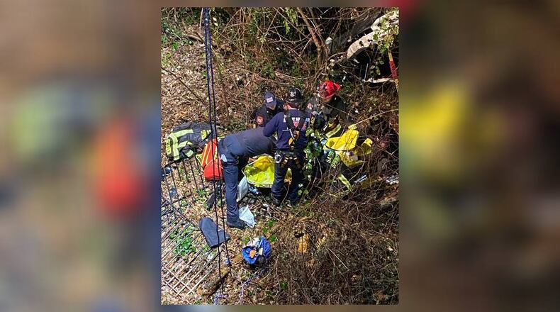 A driver was trapped in their vehicle after falling 40 feet into a ravine in Sandy Springs on Wednesday night. (Credit: Sandy Springs Fire Department)