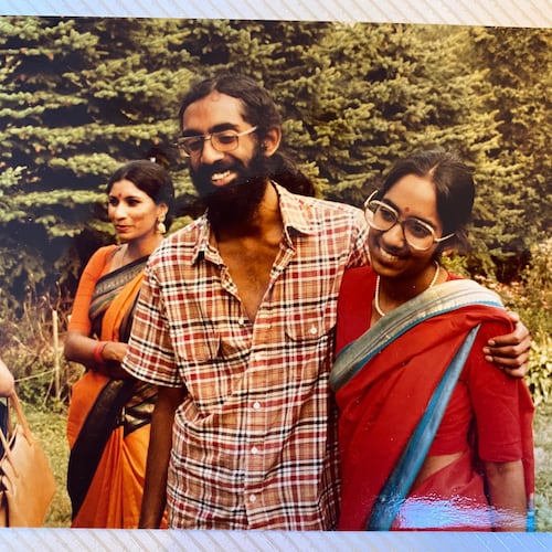 Tejaswini Rao chats with party guests while Subramanyam and Saraswathi Vedam embrace during their parents' wedding anniversary party at State College, Pa., in August 1981. (Saraswathi Vedam via AP)
