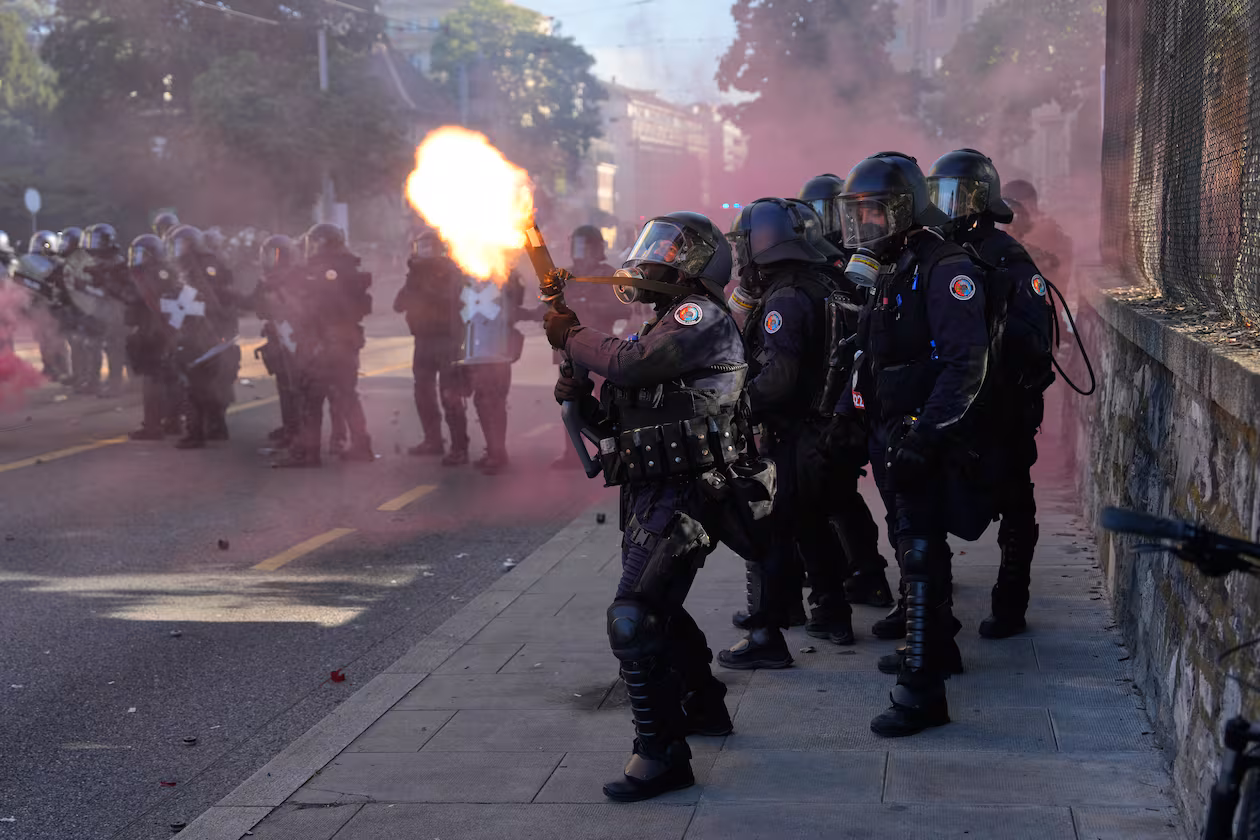 Police fire a tear gas canister during a "No G7" demonstration in Geneva, Switzerland, Sunday, June 14, 2026, ahead of the G7 summit scheduled to take place June 15-17. (AP Photo/Baz Ratner)