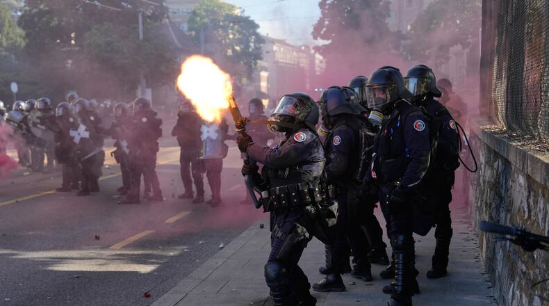 Police fire a tear gas canister during a "No G7" demonstration in Geneva, Switzerland, Sunday, June 14, 2026, ahead of the G7 summit scheduled to take place June 15-17. (AP Photo/Baz Ratner)