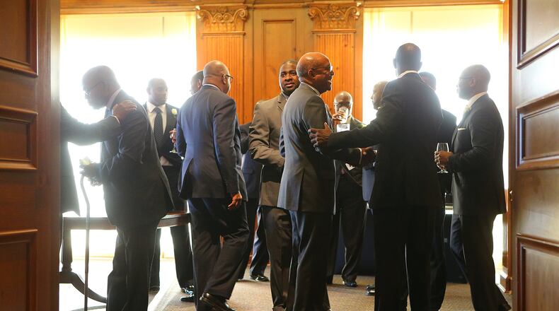 New and old members of 100 Black Men of Atlanta mingle last week at The Commerce Club.