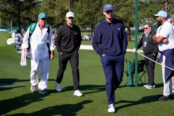 Rasmus Hojgaard, left, and Nicolai Hojgaard walk to the tee on the eighth hole during a practice around at the Masters golf tournament, Wednesday, April 9, 2025, in Augusta, Ga. (AP Photo/Ashley Landis)